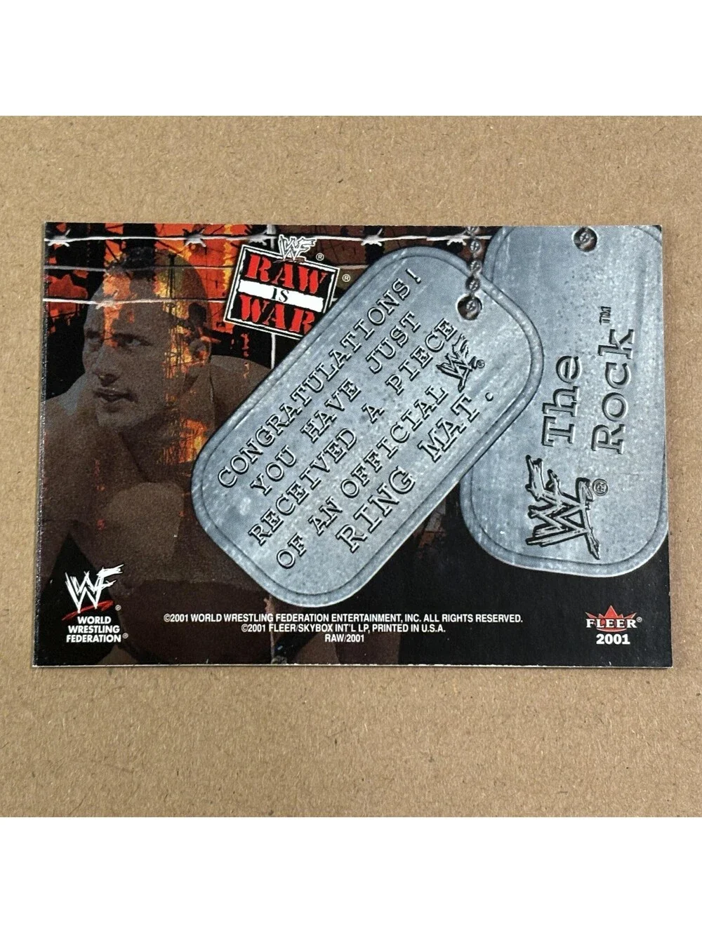 2001 Fleer WWF Raw Is War The Rock #NNO War Booty Mat Relic